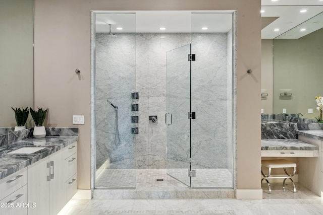 full bath featuring a marble finish shower, recessed lighting, vanity, and marble finish flooring
