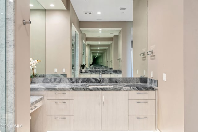 full bathroom featuring vanity and recessed lighting