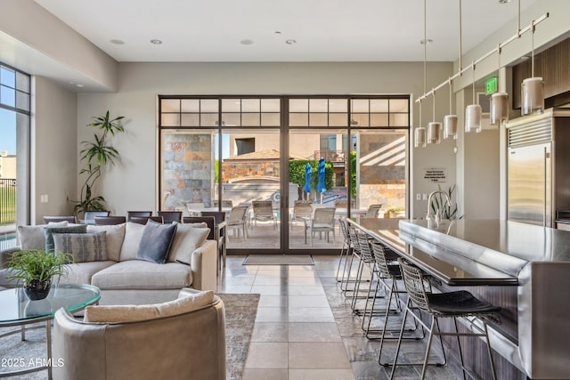 living area featuring tile patterned flooring and recessed lighting