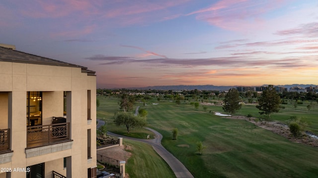 view of city featuring a golf course and a mountain backdrop