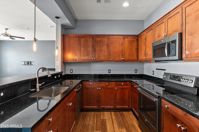 19475 N Grayhawk Dr Unit 2151, Scottsdale, AZ 85255 - kitchen with stainless steel appliances, a sink, a ceiling fan, dark wood-style flooring, and dark stone countertops