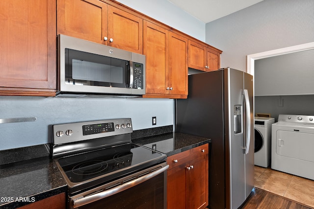 19475 N Grayhawk Dr Unit 2151, Scottsdale, AZ 85255 - kitchen featuring stainless steel appliances, independent washer and dryer, brown cabinetry, and dark stone counters