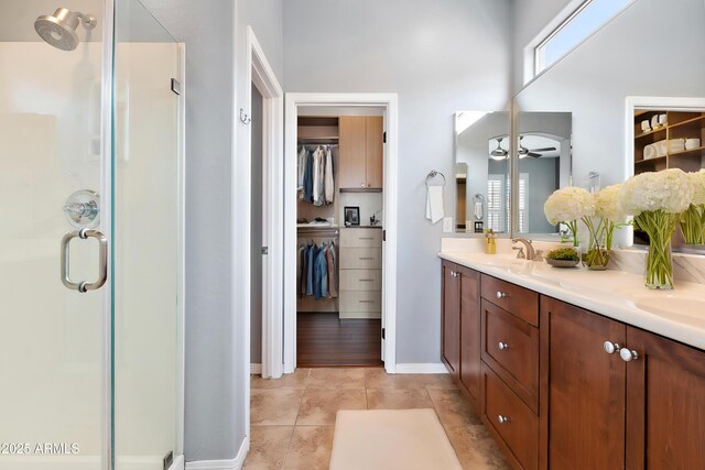 19475 N Grayhawk Dr Unit 2151, Scottsdale, AZ 85255 - full bathroom with a stall shower, double vanity, a walk in closet, and baseboards