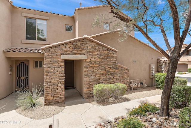 19475 N Grayhawk Dr Unit 2151, Scottsdale, AZ 85255 - view of front facade featuring stucco siding, a tile roof, and stone siding