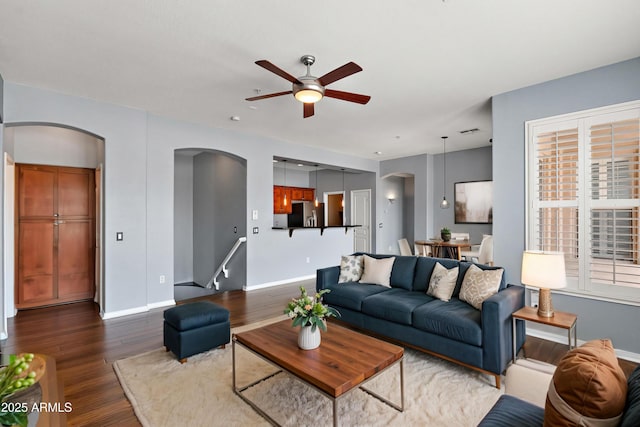 19475 N Grayhawk Dr Unit 2151, Scottsdale, AZ 85255 - living area with arched walkways, a ceiling fan, dark wood finished floors, and baseboards