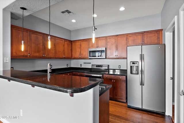 19475 N Grayhawk Dr Unit 2151, Scottsdale, AZ 85255 - kitchen with stainless steel appliances, dark countertops, dark wood-type flooring, hanging light fixtures, and recessed lighting