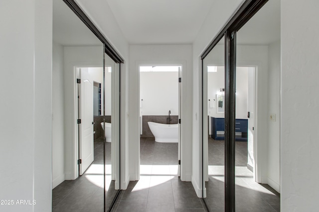 hall with dark tile patterned floors