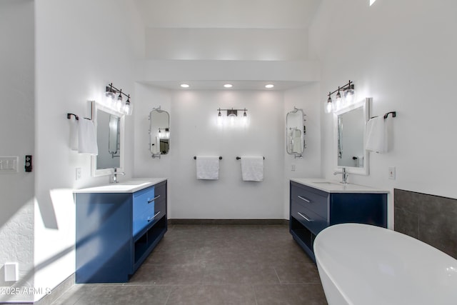 bathroom featuring two vanities, a sink, and tile patterned floors