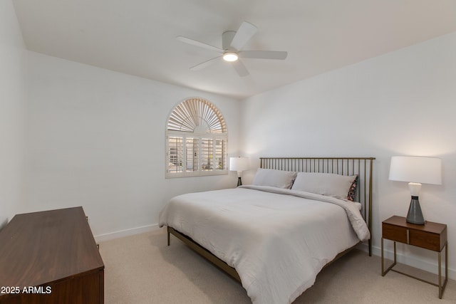 bedroom with light carpet, a ceiling fan, and baseboards