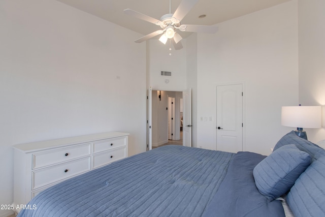 bedroom featuring high vaulted ceiling, ceiling fan, and visible vents