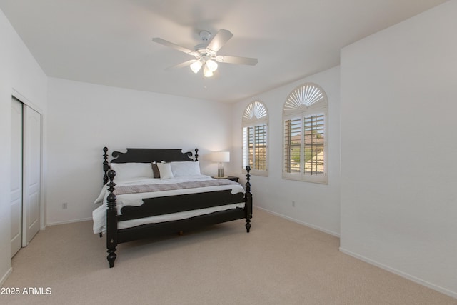 bedroom with light carpet, ceiling fan, and baseboards