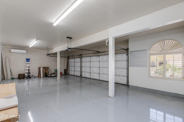 garage featuring a wall mounted AC and a garage door opener