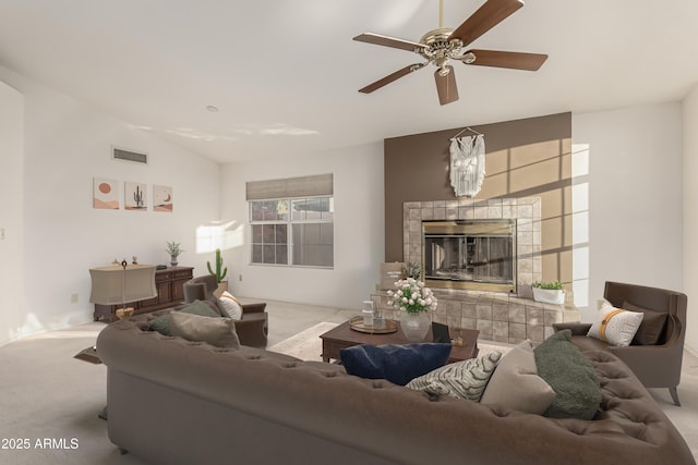 living room with carpet, a tile fireplace, and visible vents