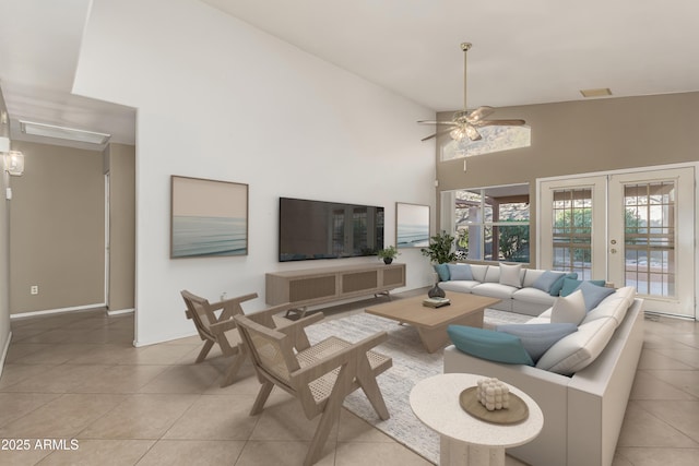 living area with french doors, light tile patterned floors, visible vents, a ceiling fan, and high vaulted ceiling