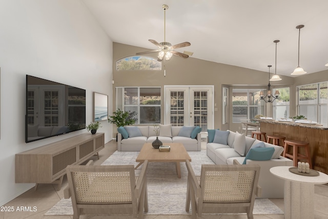 sunroom / solarium with vaulted ceiling, french doors, and ceiling fan with notable chandelier