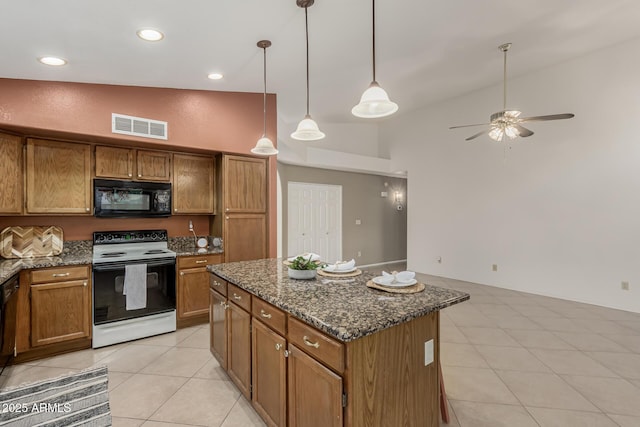 kitchen with black microwave, electric range oven, visible vents, and brown cabinets