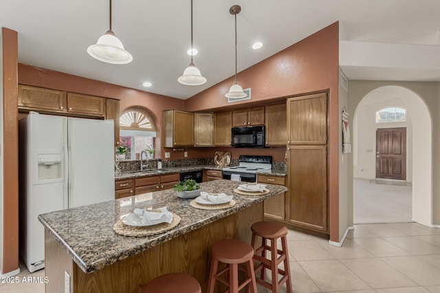 kitchen featuring arched walkways, a sink, vaulted ceiling, brown cabinets, and black appliances