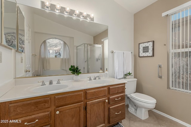 bathroom featuring toilet, tile patterned floors, vaulted ceiling, a shower stall, and a sink