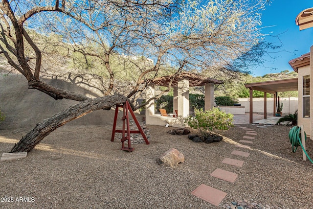 view of yard with fence and a patio