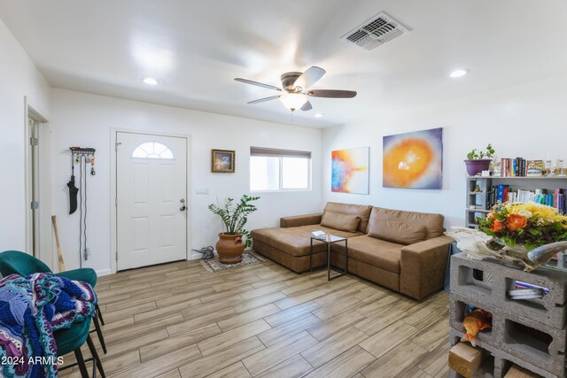 living room with ceiling fan and light hardwood / wood-style floors