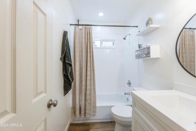 full bathroom featuring hardwood / wood-style floors, vanity, toilet, and shower / bath combo