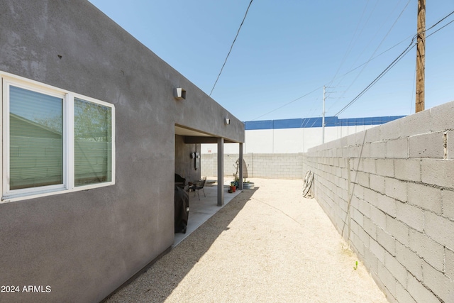 view of side of home with a patio area