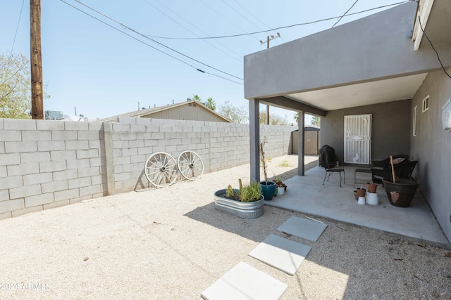 view of patio with a storage unit