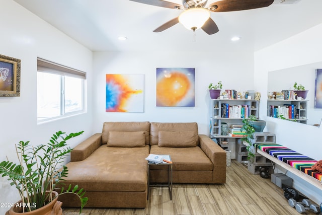 living room featuring light hardwood / wood-style floors and ceiling fan