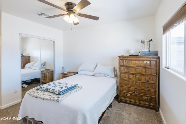 carpeted bedroom featuring ceiling fan and a closet