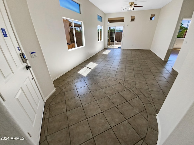 tiled entryway with ceiling fan