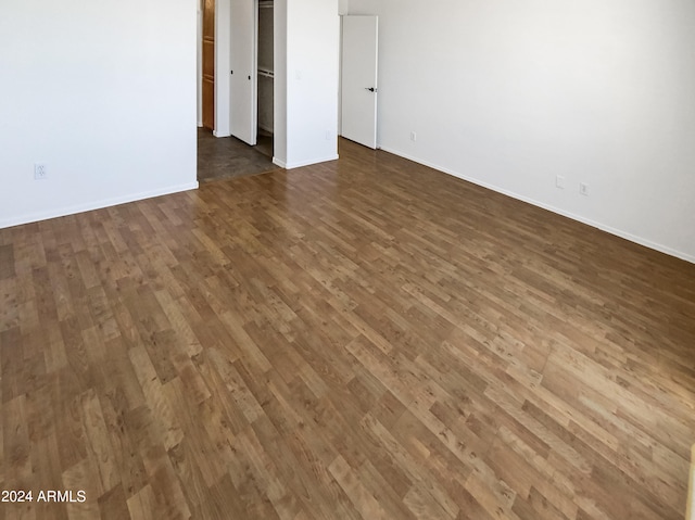 unfurnished room featuring dark wood-type flooring