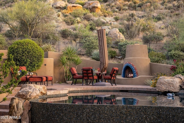 exterior space featuring exterior fireplace and a patio area