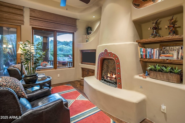 living room featuring dark hardwood / wood-style flooring and a large fireplace