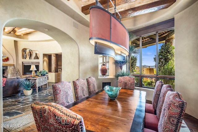 dining area featuring a towering ceiling