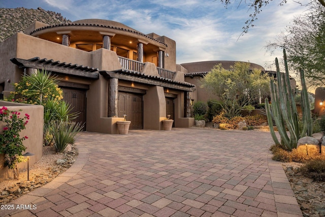 adobe home featuring a balcony