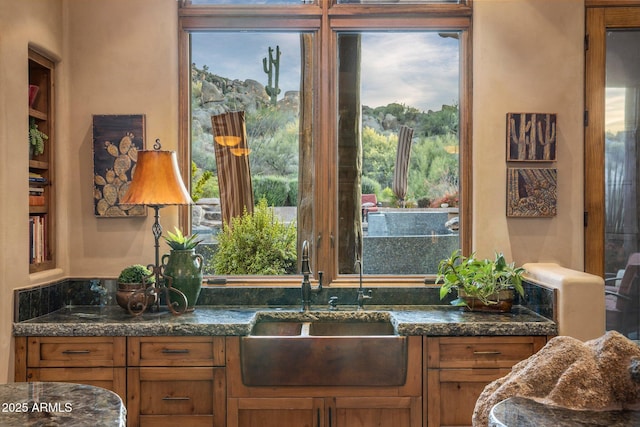 interior space featuring dark stone counters and sink