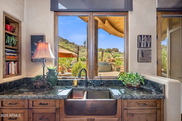 kitchen with dark stone countertops and sink