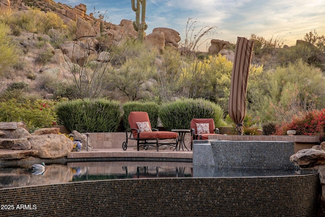 view of patio terrace at dusk