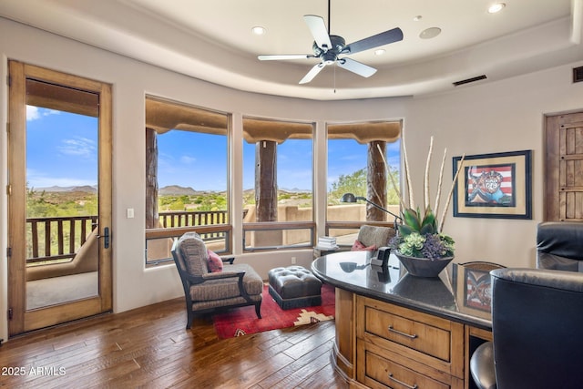 office featuring dark wood-type flooring, plenty of natural light, a raised ceiling, and ceiling fan