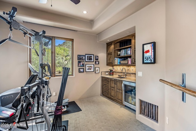 workout area featuring wet bar, wine cooler, and ceiling fan