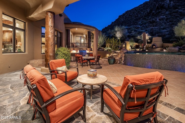 patio at night with a mountain view and outdoor lounge area