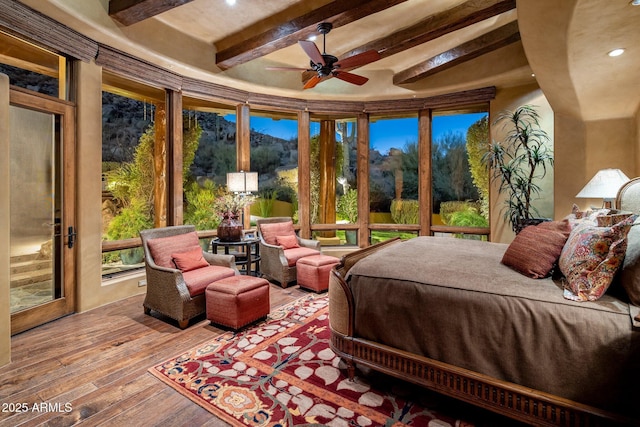 bedroom featuring hardwood / wood-style flooring and beamed ceiling