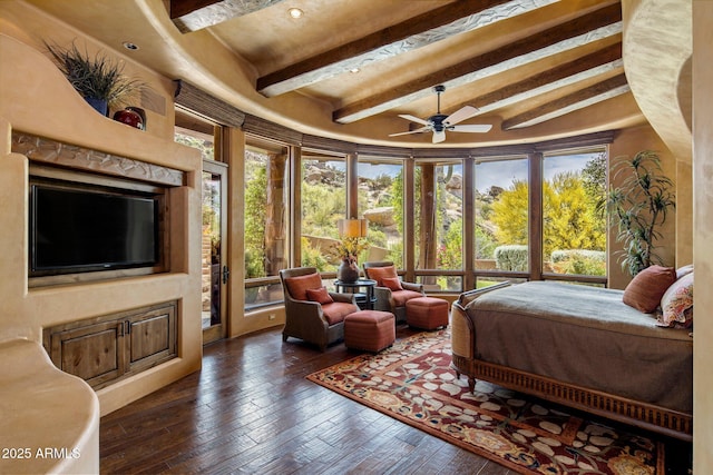 bedroom with dark hardwood / wood-style flooring, beam ceiling, and multiple windows