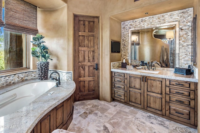 bathroom with vanity and a bath