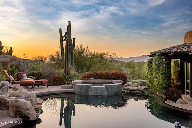 exterior space with a mountain view and a patio area