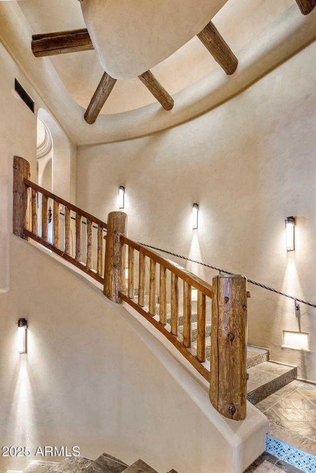 stairs featuring a towering ceiling