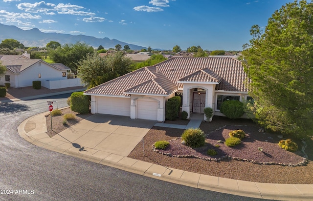 mediterranean / spanish-style house featuring a mountain view and a garage