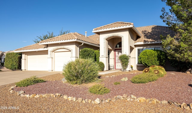 mediterranean / spanish-style home with a garage