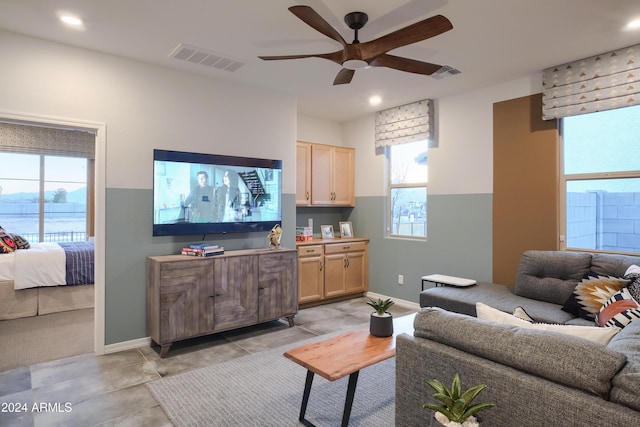 living room with a wealth of natural light and ceiling fan