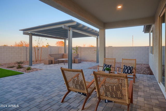 patio terrace at dusk featuring an outdoor hangout area